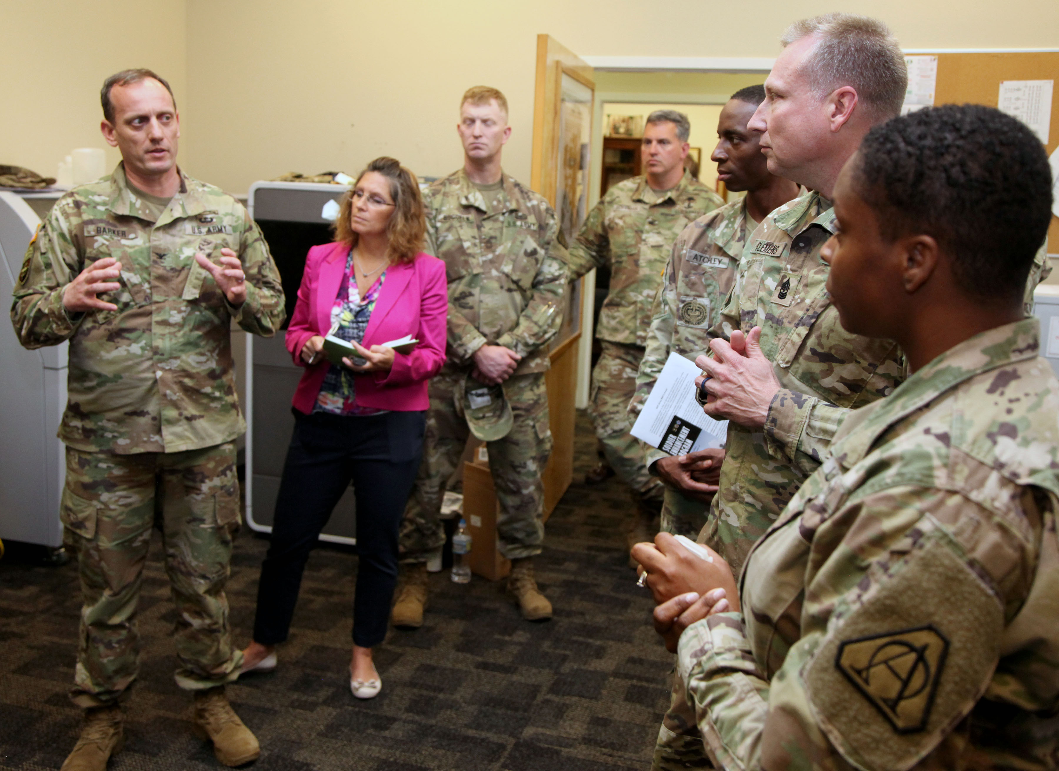 Barker, left, briefs civilians, military members, and industry representatives in April at Fort Belvoir on the mission and capabilities of the project manager for Soldier Warrior. Integration of systems, which Barker considers the biggest challenge of his work, requires good communication at the concept or design stage, he said. (Photo by PM SWAR staff)