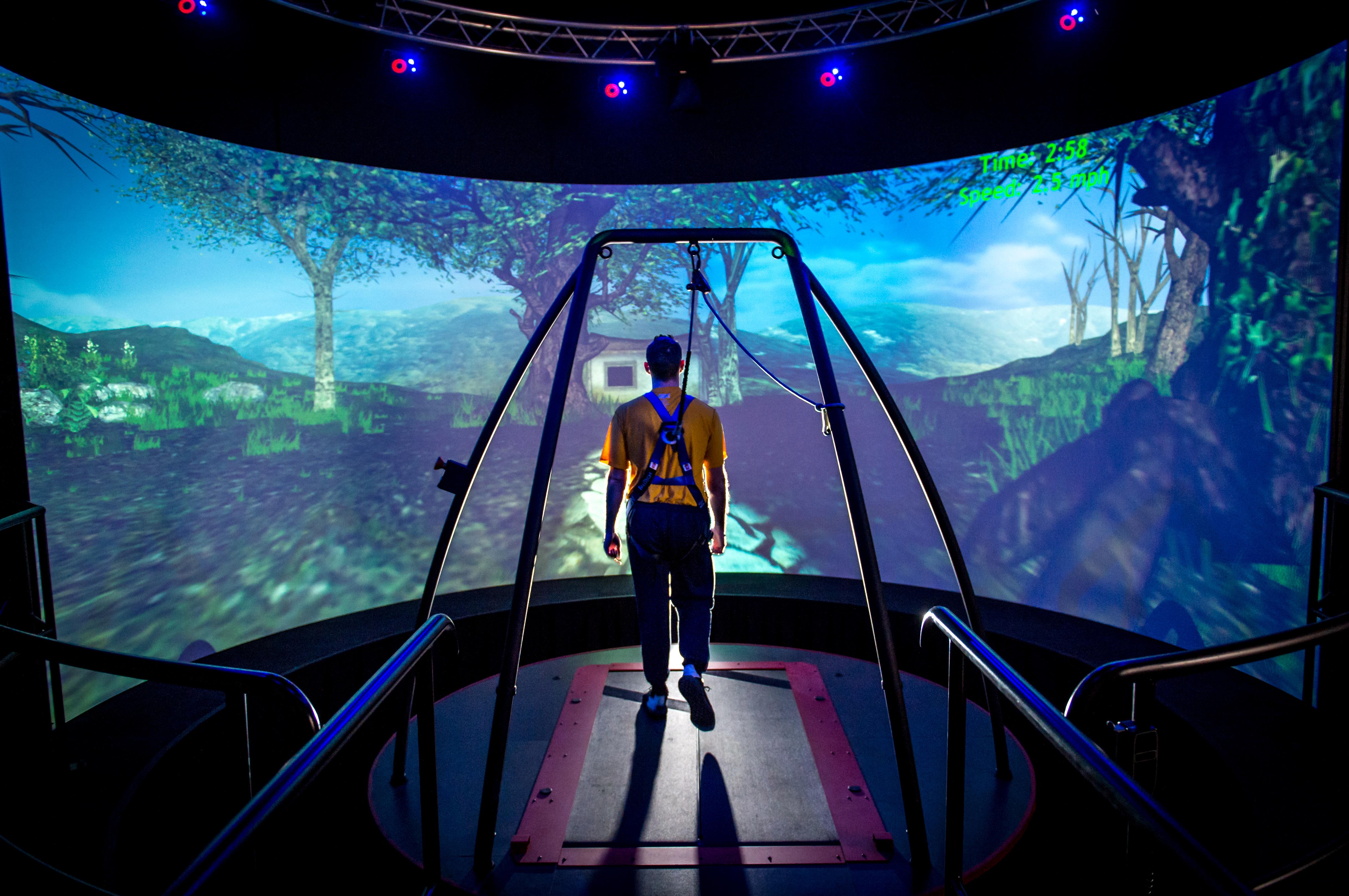 A traumatic brain injury patient walks through a virtual reality scenario at the Computer Assisted Rehabilitation Environment Laboratory at the National Intrepid Center of Excellence in Bethesda, Maryland, in March. Cameras track the patient's movements and supply data to physical therapists. Similar approaches seeking to optimize treatment are being explored through the White House Precision Medicine Initiative, which aims to provide clinicians with new tools for treatment selection, taking into account differing symptoms, environments and lifestyles. (U.S. Air Force photo by J.M. Eddins Jr.)