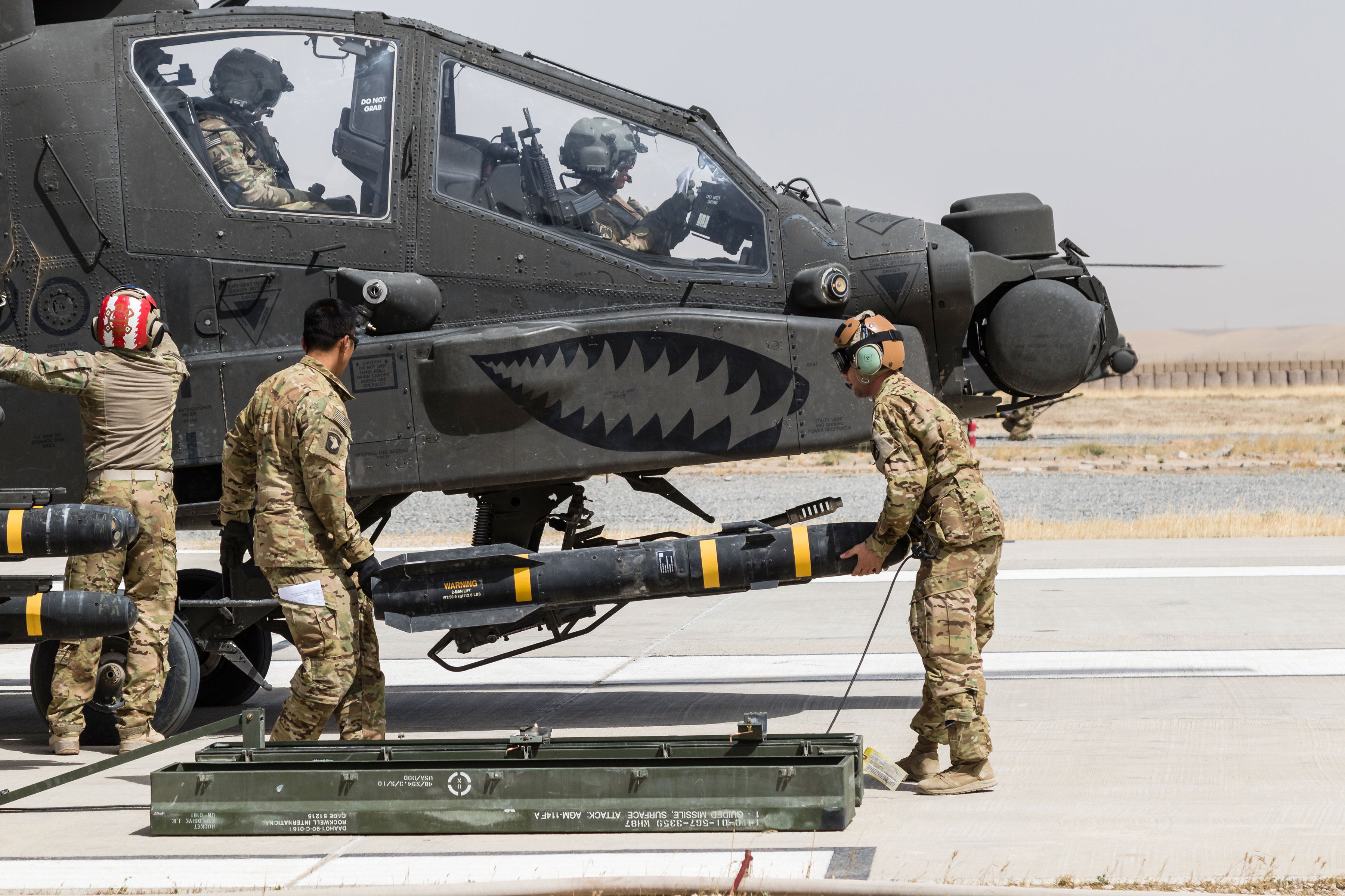 Soldiers assigned to Task Force Griffin, 16th Combat Aviation Brigade (CAB), 7th Infantry Division load an AGM-114 HELLFIRE missile on an AH-64E Apache helicopter in Kunduz, Afghanistan, in May. This support for U.S. Forces Afghanistan is possible, in turn, because of long-standing, ongoing relationships between government and the private sector in research and development. Cultivating and maintaining such ties helps Army acquisition ensure that its development and acquisition strategies will produce the best, most up-to-date and effective equipment. (U.S. Army photo by Capt. Brian Harris, 16th CAB)