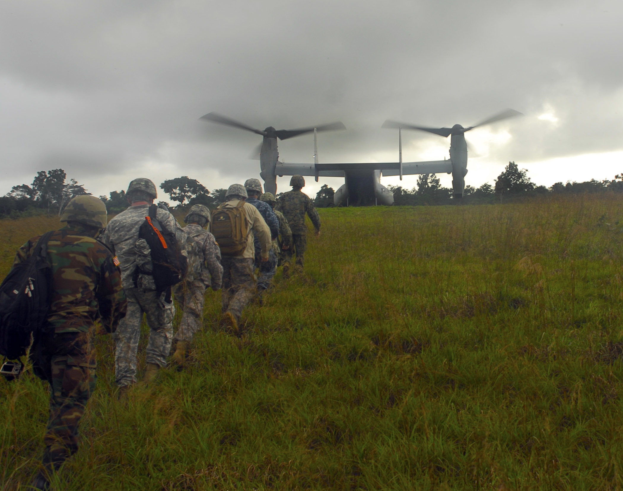 U.S. Army and Marine Corps personnel prepare to board a U.S. Marine Corps MV-22 aircraft in October 2014 after surveying the site of a future Ebola treatment unit near Barclayville, Liberia. The U.S. military forces in West Africa during the Ebola outbreak worked well with the civilian machinery running the response, Aylward says, adding that U.S. aircraft “came in real handy getting out to some of these remote areas.” (U.S. Army Africa photo by Pfc. Craig Philbrick)