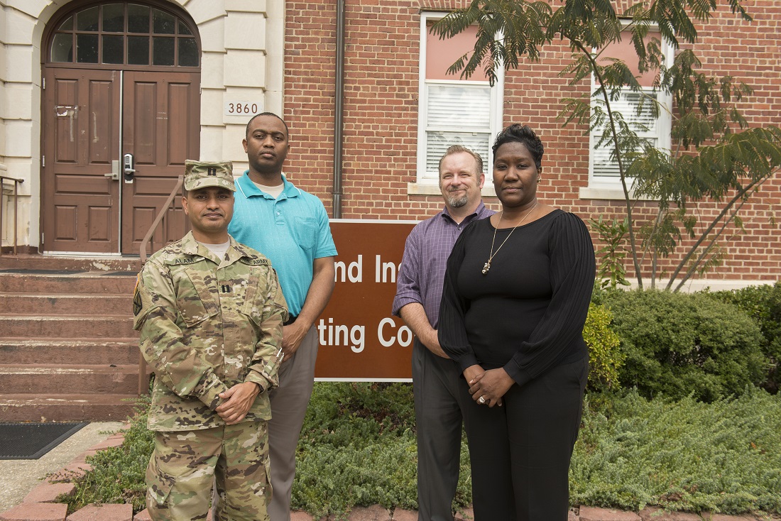 MICC-Fort Bragg contracting officer Nicole Jones, right, credits much of her success to her co-workers, including, from left, Capt. Safiul Alam and Shondell Jordan, tenant contract specialists, and Michael Pressley, Tenant Division chief.