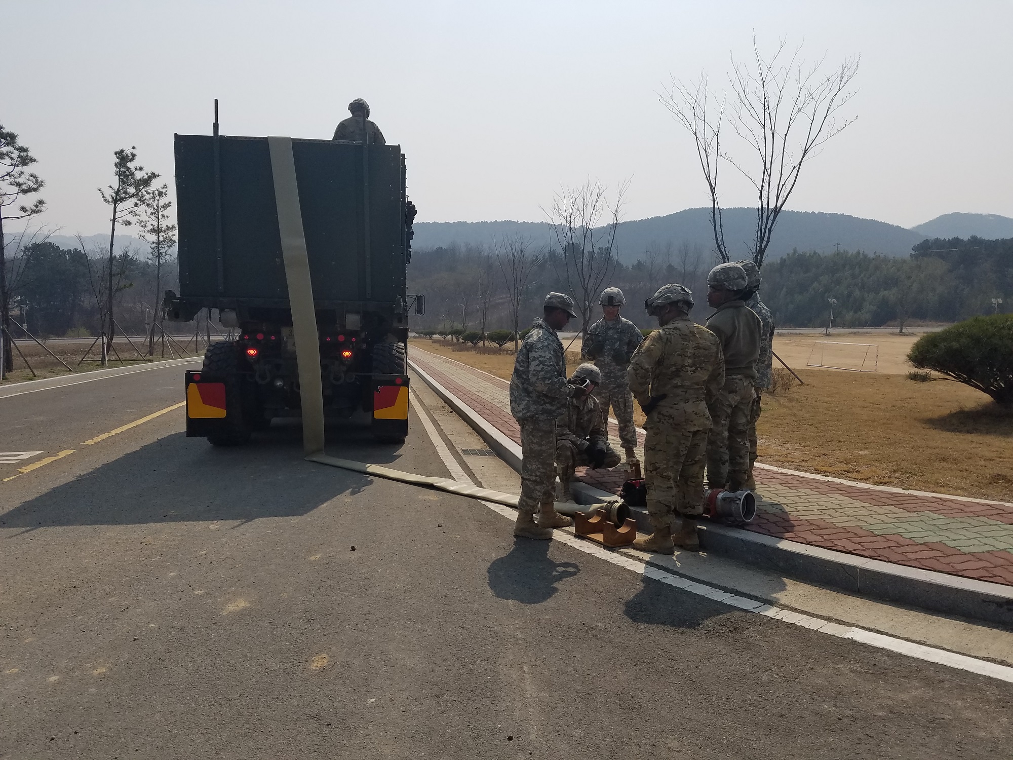 Soldiers from the 339th Quartermaster Company and the 498th Combat Service Support Battalion used existing culverts to thread 9,500 feet of lay-flat hose though pipes during the Combined Joint Logistics Over-the-Shore exercise at Pohang, South Korea, last spring. The hose is part of the Fight Tonight Emergency Fuel Distribution System, which can deliver 720,000 gallons of fuel per day. (U.S. Army photo by Drew Downing, RDECOM)