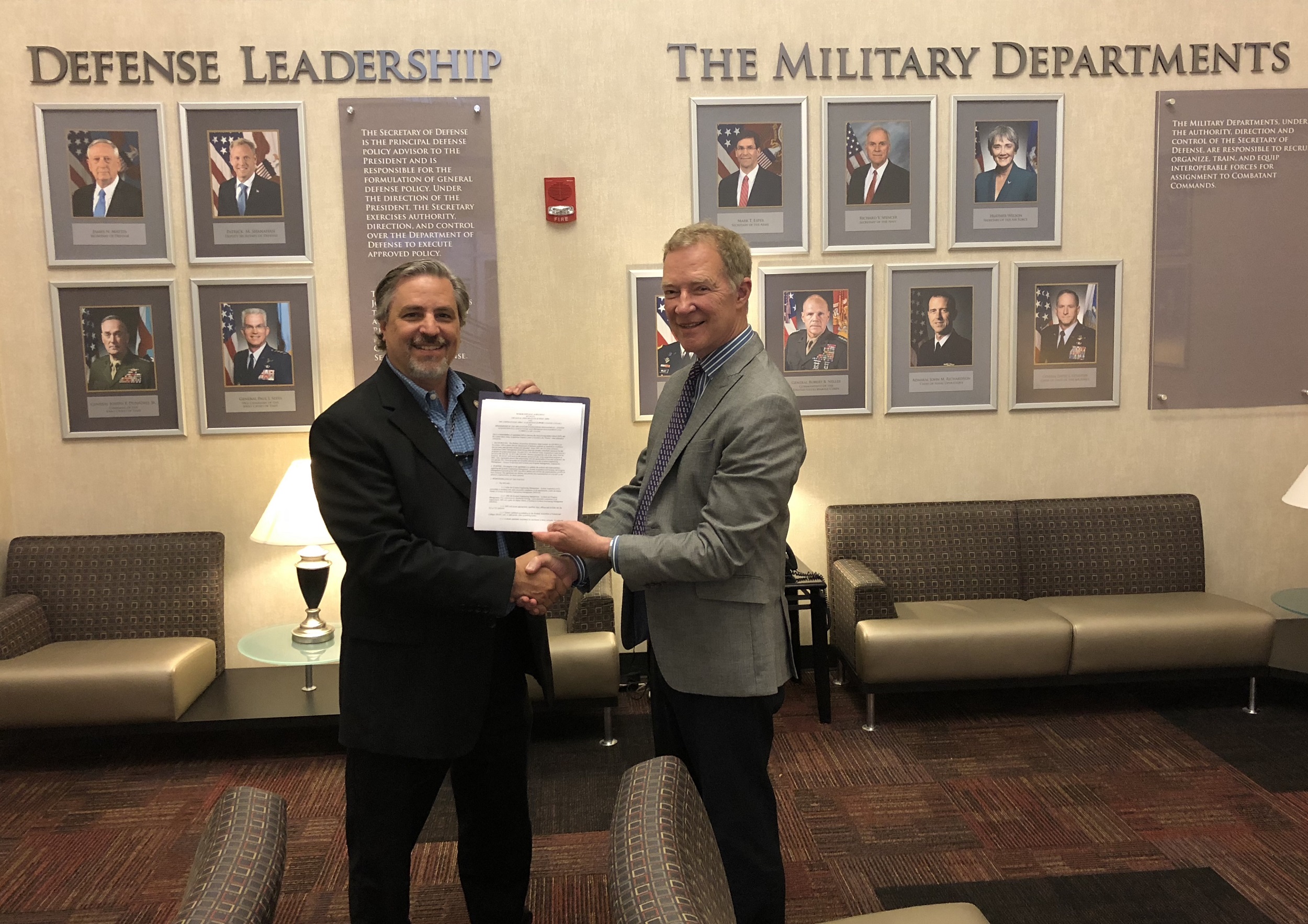 Craig A. Spisak, left, the Army DACM, and Professor John T. Dillard, Col., USA (Ret.), NPS senior lecturer in systems acquisition management and technical representative for the new curricula, hold the memorandum of agreement signed by Lt. Gen. Paul A. Ostrowski and NPS President Ronald A. Route, Vice Adm., USN (Ret.), on May 18 at the Pentagon. The memorandum cements a partnership to provide relevant education to the Army’s military and civilian acquisition workforce. (Photo courtesy of John T. Dillard)