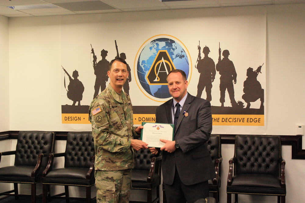 Warner receives the Achievement Medal for Civilian Service May 3, 2018, from Brig. Gen. Robert Marion, deputy for acquisition and systems management within ASA(ALT). Photo by Maj. Thomas Kralyn, ASA(ALT) Acquisition Reporting and Assessments Office