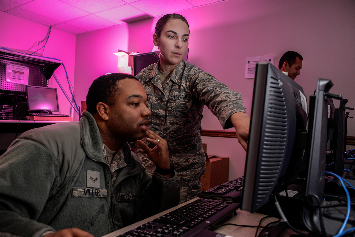 Airman 1st Class Tevin Miller and Airman 1st Class Amanda Button, 707th Communications Squadron client system technicians, update software for computers that will be used on Air Force networks in January at Fort Meade, Maryland. Joint forces, coordinating from command centers to the warfighter in the field, will use integrated software systems that allow for early warning and situational understanding. The Analytical Framework’s goal is to get capabilities like these into the hands of warfighters sooner. (U.S. Air Force photo by Staff Sgt. ¬Alexandre Montes, 70th Intelligence, Surveillance and Reconnaissance Wing)
