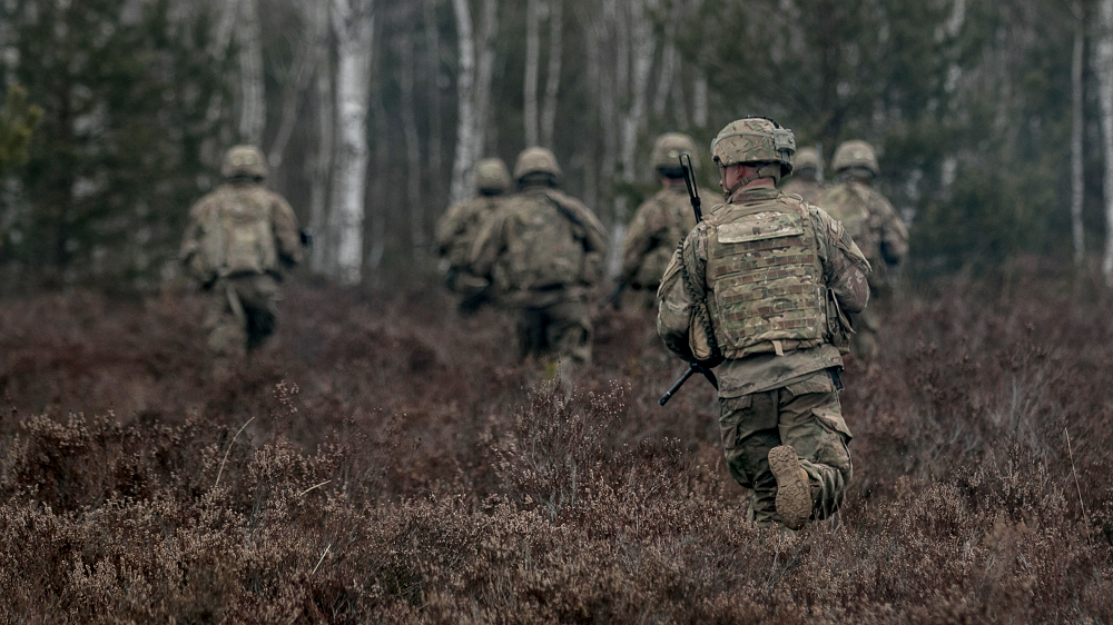 Soldiers assigned to 2nd Armored Brigade Combat Team, 1st Infantry Division, at Fort Riley, Kansas, move into nearby woods during a platoon combined arms live-fire exercise at Presidenski Range in Trzebian, Poland, March 26. The author, who was program manager of the search for a new camouflage pattern, explains that there are two ways to go wrong with test and evaluation: Cutting back on testing too aggressively, in pursuit of cost savings, puts the program at risk, while demanding more expensive field testing in the mistaken belief that it’s more accurate drives the budget up. (U.S. Army photo by Spc. Dustin D. Biven, 22nd Mobile Public Affairs Detachment)