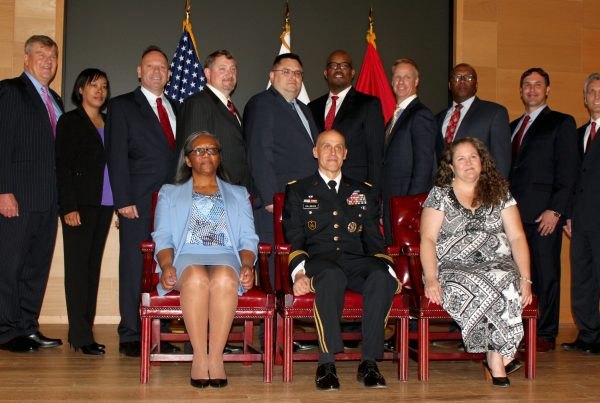 Lareina Adams, second from left, poses with other graduates, instructors and guests during Defense Acquisition University’s Senior Service College Fellowship Program graduation on May 23, 2017. Adams is currently serving as the product lead for the Headquarters Army Environmental System, PM GFEBS, at PEO EIS. She will take on her new role as product manager for Counter Explosive Hazard at PEO IEW&S in the summer of 2019. (Photo courtesy of Lareina Adams)