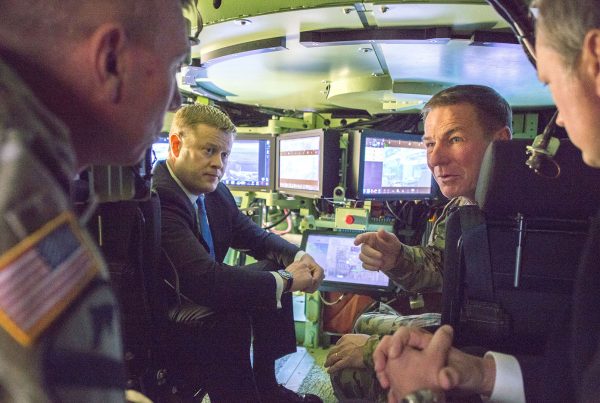 Undersecretary of the Army Ryan D. McCarthy, center left, and Gen. James C. McConville, the Army’s vice chief of staff, center right, discuss emerging technology while inside the Mission Enabling Technologies – Demonstrator, a modified Bradley Fighting Vehicle equipped with several upgrades, during a tour Jan. 18 of the Army’s Tank Automotive Research, Development and Engineering Center at the Detroit Arsenal in Michigan. RCO has pointed the way to getting new capabilities rapidly into the hands of deployed Soldiers. (U.S. Army photo by Sean Kimmons, Defense Media Activity – Army)