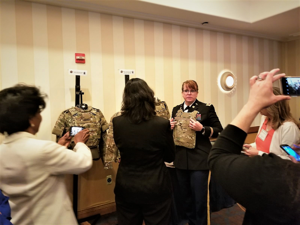 Lt. Col. Ginger Whitehead, product manager for Soldier Protection and Individual Equipment of PEO Soldier, shows members of the Defense Advisory Committee on Women Services’ the new, female-specific body armor from the Soldier Protection System. This body armor provides better fit and function to female Soldiers. (U.S. Army photo by Debra Dawson, PEO Soldier)