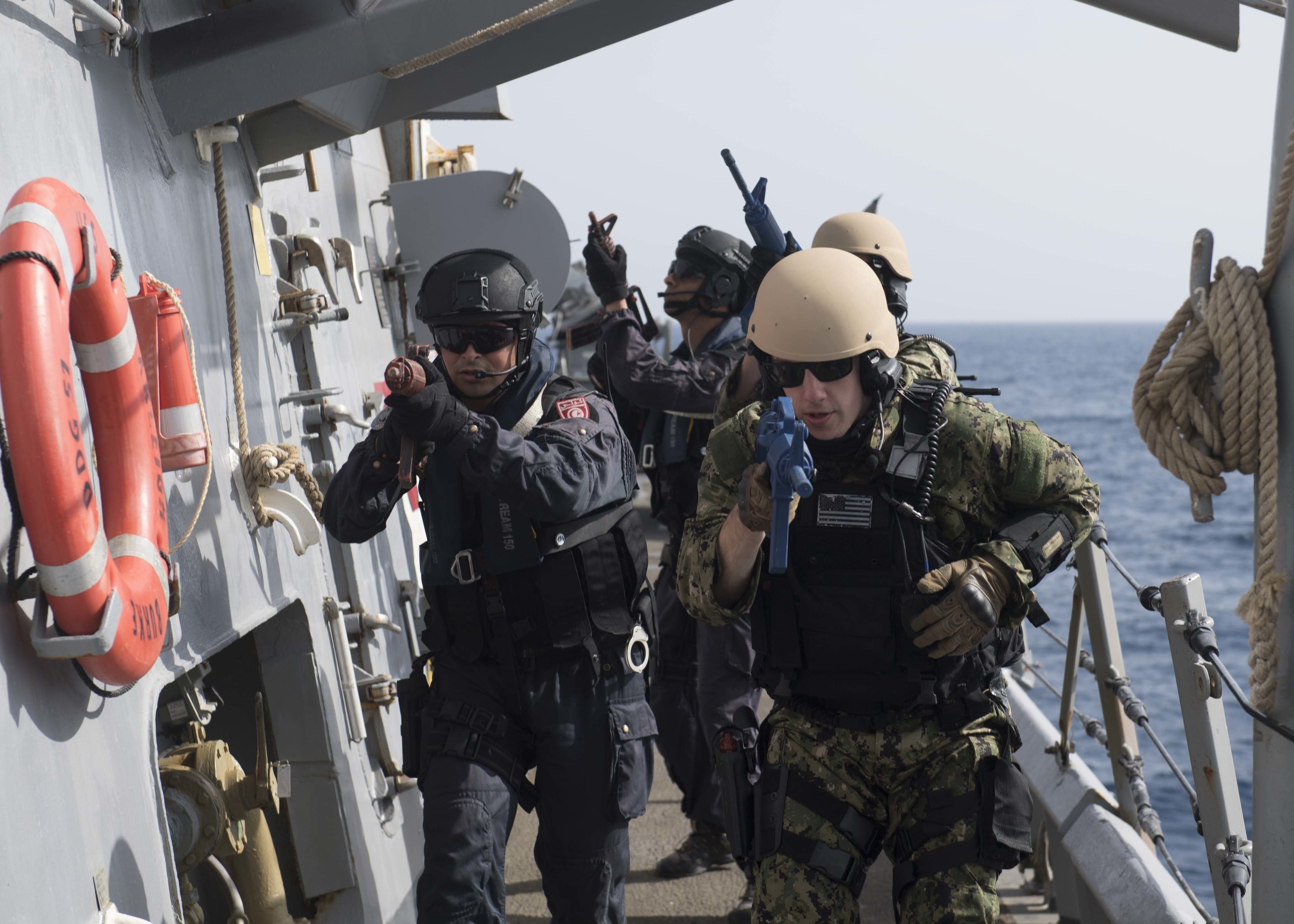 Sailors from Tunisia and the guided-missile destroyer USS Arleigh Burke (DDG 51) simulate clearing a ship during a training exercise on April 25. The Tunisian navy operates with a level of professionalism that equals its European partners, and most of its officers supplement their training with developmental opportunities with navies and industry partners around the world. (U.S. Navy photo by Mass Communication Specialist Seaman Raymond Maddocks)
