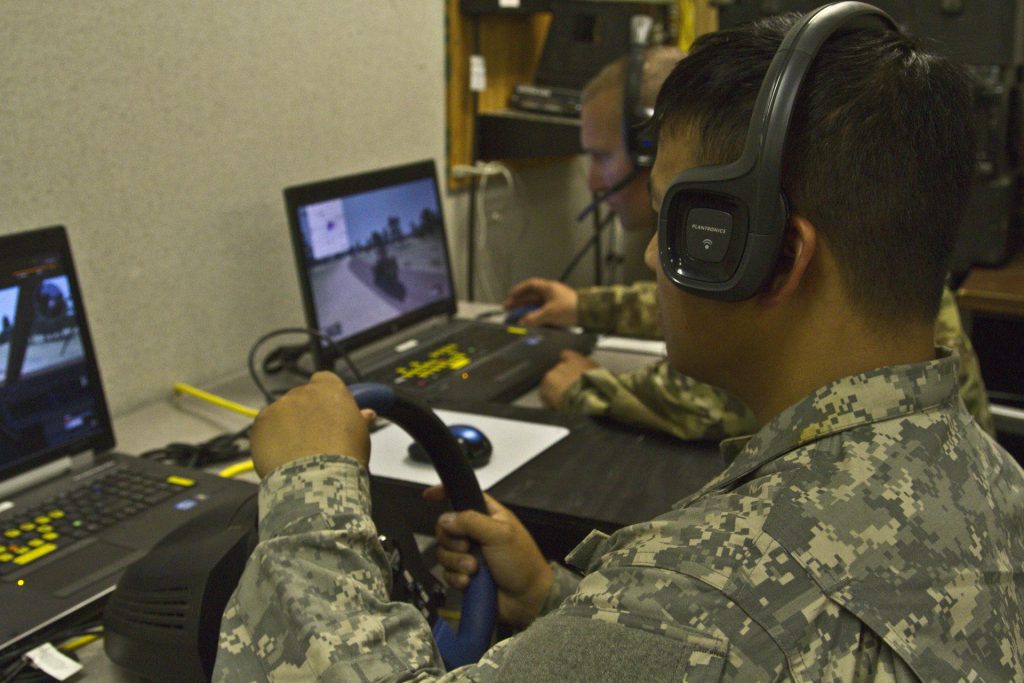 Army Reserve Soldiers Sgt. Cheng Thoa, left, and Sgt. Shawn Christensen with the 353rd Transportation Company out of Buffalo, Minnesota practice convoy operations on a virtual battlespace simulator on Fort McCoy, Wisconsin Aug. 7. (U.S. Army Reserve Photo by Staff Sgt. Anaidy G. Claudio)