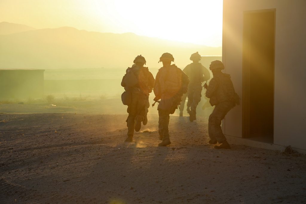 U.S. Army Soldiers assigned to 3rd Armored Brigade Combat Team, 1st Armored Division, Fort Bliss, Texas, emerge from a secured building during Decisive Action Rotation 18-08 at the National Training Center, Fort Irwin, Calif., June 6, 2018. Decisive Action Rotations at the National Training Center ensure Army BCTs remain versatile, responsive, and consistently available for current and future contingencies. (U.S. Army photo by Sgt. JD Sacharok, Operations Group, National Training Center)