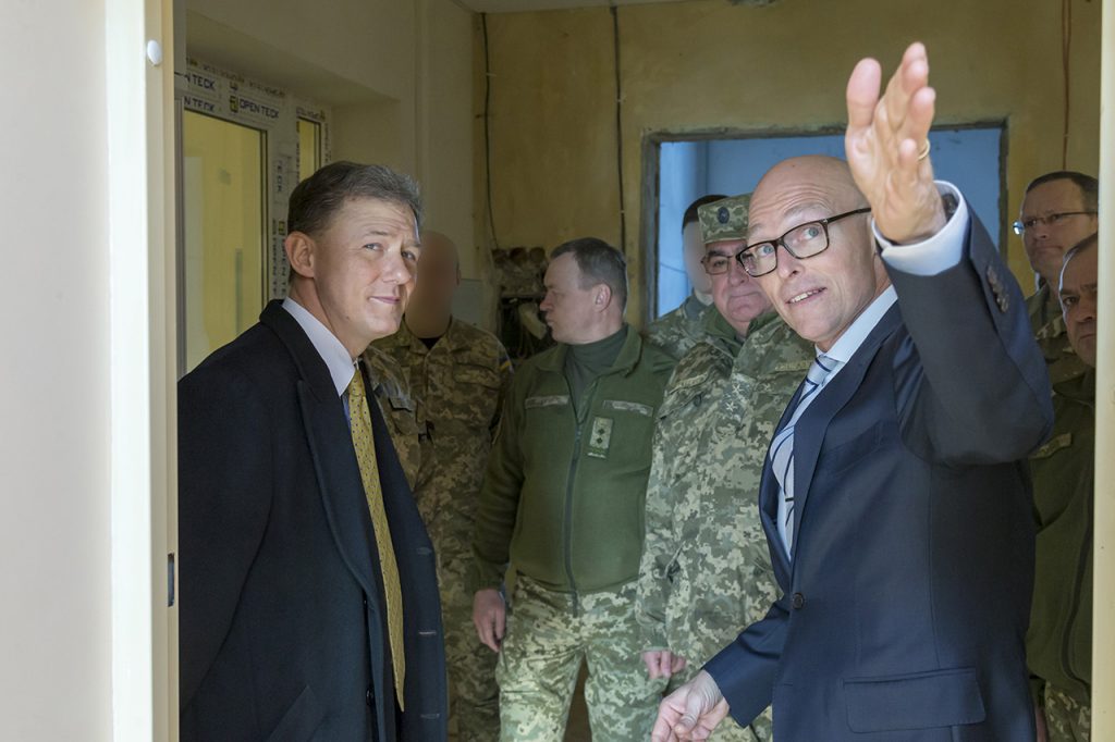 AIT Country Program Manager for Ukraine, Mr. Dan Hawkins (far right), briefing U.S. Deputy Ambassador to Ukraine, Mr. George Kent (left), and Ukrainian Deputy Chief of Defense, Lieutenant General Serhii Bessarab (center) on the new Ukranian Special Operations Forces training facilities (location in Ukraine undisclosed) being outfitted by AIT with various C4ISR and Defensive Cyber capabilities, January 2018. Photo credit: Mr. Jeremy Way, AIT support contractor