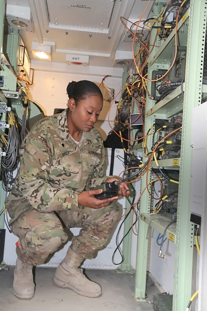 A Soldier from the 4th Infantry Brigade Combat Team, 3rd Infantry Division ensures her communication systems inside a tactical mobile station for the network is secure by using a simple key loader. (Photo courtesy of PEO C3T)