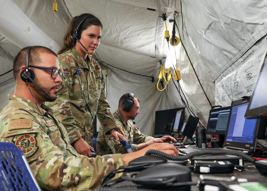 THIS IS WARFARE: Military service members assigned to the 7th Air Support Operations Squadron, Fort Bliss, Texas, and 729th Air Control Squadron, Hill Air Force Base, Utah, conduct warfare operations at the Technical Operation Center-Lite on Oct. 14 during Project Convergence 22 experimentation at March Air Reserve Base, California. (Photo by Spc. Brenda Salgado Morales, Army Futures Command)