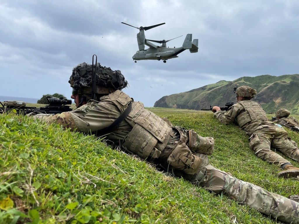 LAND OR SEA Soldiers with the 25th ID, Marines from the 3d Marine Littoral Regiment and soldiers of the Armed Forces of the Philippines secure an objective on Basco Island, Philippines as part of their amphibious air assault training exercise during Balikatan, part of the Operation Pathways exercises, April 23, 2023. The 25th ID is serving as the exercise’s division unit of action and using the Integrated Tactical Network to conduct operations all the way down to the edge. (Photo by Maj. Jeffrey Tolbert)