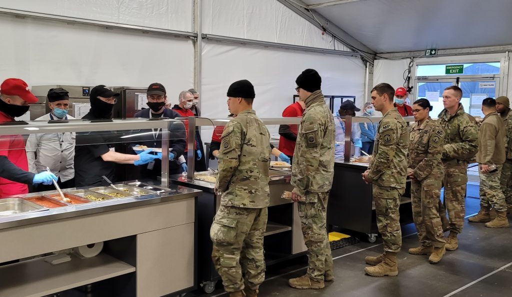 CHOW LINE Soldiers from elements of the XVIII Airborne Corps deployed to Mielec, Poland, stand in line for dinner at a dining facility tent. (Photo by Lt. Col. Alan Manzo, 405th Army Field Support Brigade – Europe & Africa)