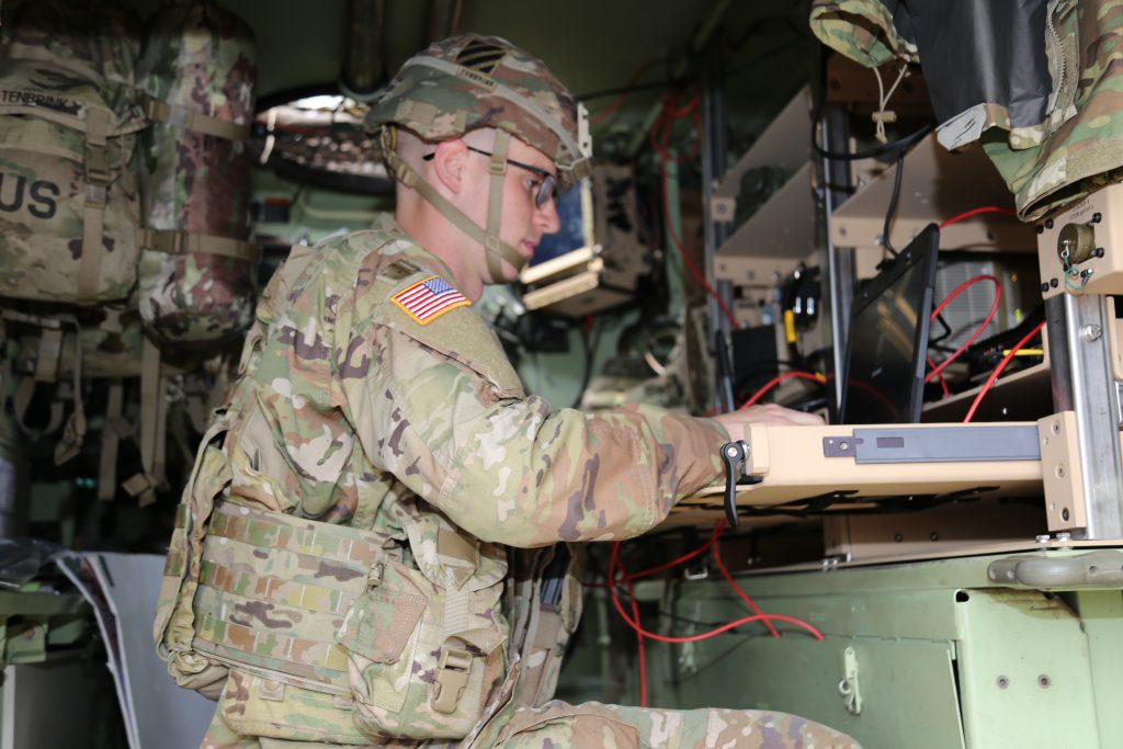 REMOTE COMMUNCATION: During the first phase of the pilot in February 2022, 1st Lt. T.J. Allen, the communications and network officer assigned to the 2nd Armored Brigade Combat Team, 3rd Infantry Division, communicates with the brigade headquarters from inside his network-integrated tracked vehicle at a remote location at Fort Stewart, Georgia. (Photo by Amy Walker, PEO C3T Public Affairs)