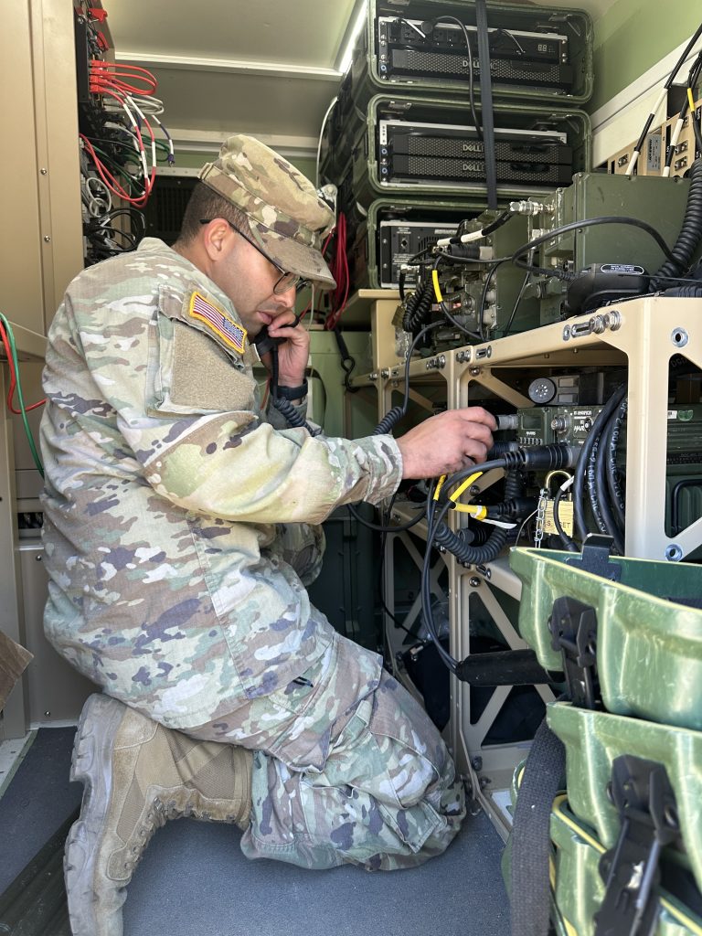 PREPARE TO “JUMP”: Soldiers with 1st Stryker Brigade Combat Team, 2nd Infantry Division prepare to move the command post during the Command Post Integrated Infrastructure (CPI2) Validation Exercise on July 26, 2023, at Joint Base Lewis-McChord, Washington. The CPI2 program provides mobile command post capabilities by integrating network and communications technologies into a family of medium tactical vehicle platforms for on-the-move command post capabilities. (Photo by Kathryn Bailey, PEO C3T)