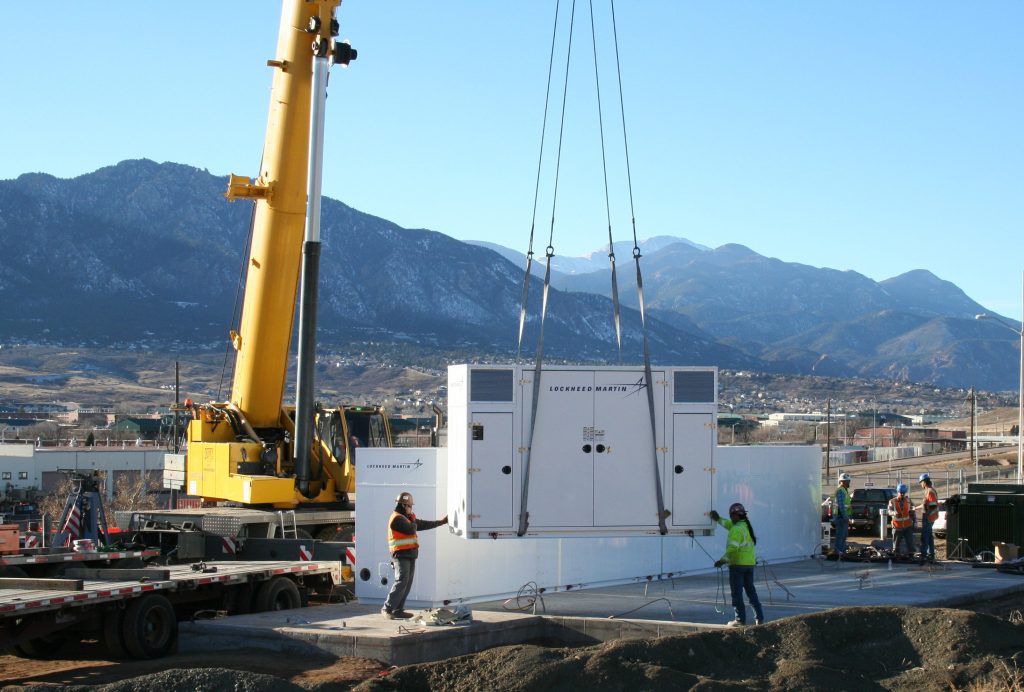 WORKING TOWARD COST REDUCTION: Workers install portions of the 8.5 megawatt-per-hour battery system at Fort Carson, Colorado. Huntsville Center’s Energy Savings Performance Contracting program coordinated the project, designed to reduce peak electricity use costs, especially during the summer cooling season. (Photo courtesy of U.S. Army Engineering and Support Center ‒ Huntsville)