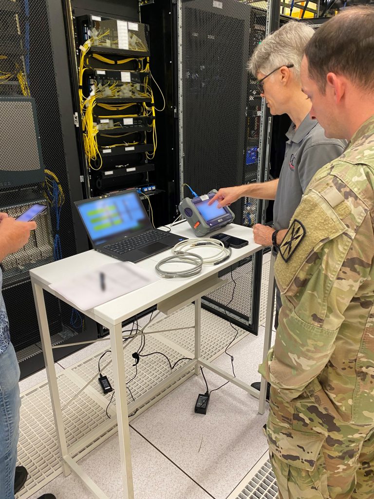TEST MODE: Chief Warrant Officer 2 Stephen Wallace, 516th Signal Brigade senior network technician, and Dan Marcum, a CACI engineer, test circuits during the GENM-O Pacific Theater’s systems acceptance test in Okinawa, Japan, May 12-16, 2023. (Photo by Alexandra Passoff, GENM-O)