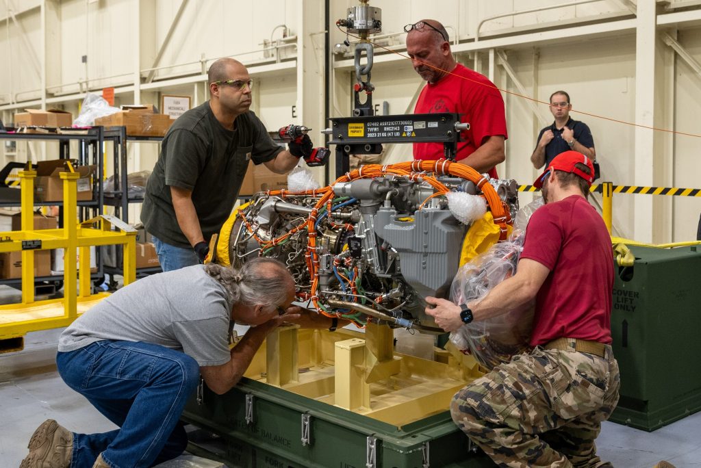 NEW AND IMPROVED: Team members remove a recently delivered T901 engine from its shipping crate in West Palm Beach, Florida. (Photo by David Hylton, Program Executive Office, Aviation)