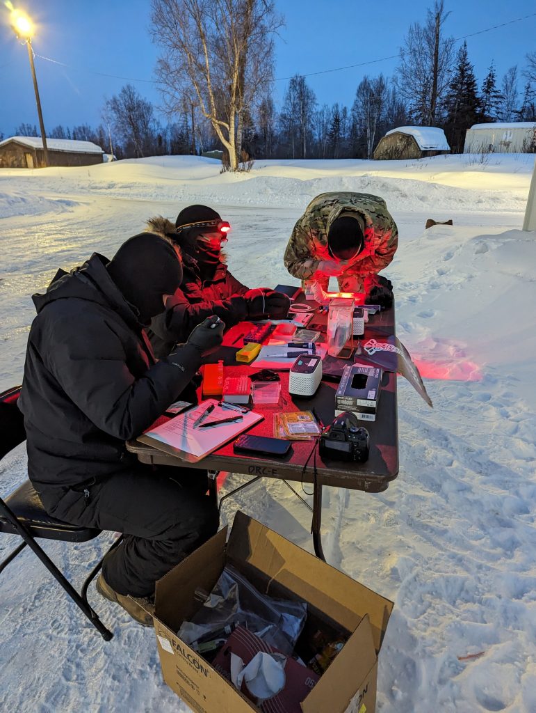 FREEZE FRAME: From left: Paul Kallgren, William Dorman, and Capt. Ian Davis of the U.S. Army Medical Research Institute of Infectious Diseases Diagnostic Systems Division conduct extreme cold weather testing on PCR and handheld assays before sunrise to achieve the coldest possible environment at Camp Mad Bull, Joint Base Elmendorf-Richardson, Alaska, during Exercise Arctic Edge 2024. (Photo courtesy of USAMRIID Public Affairs Office) 