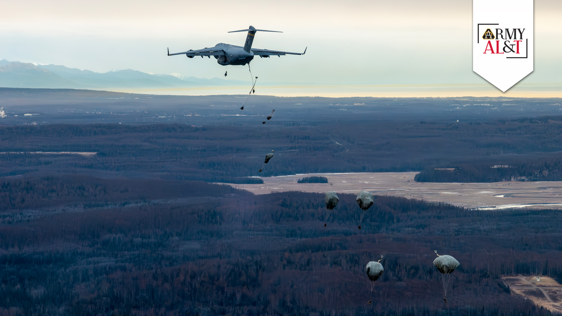 JUMPING THE GUN: U.S. Army Soldiers assigned to 2/11 IBCT(A) conduct a jump from a C-17 Globemaster III during the Joint Pacific Multinational Readiness Center 24-1 exercise at Malemute Drop Zone, Alaska, in November 2023. (Photo by Mysti Bicoy, 154th Wing, Hawaii Air National Guard)