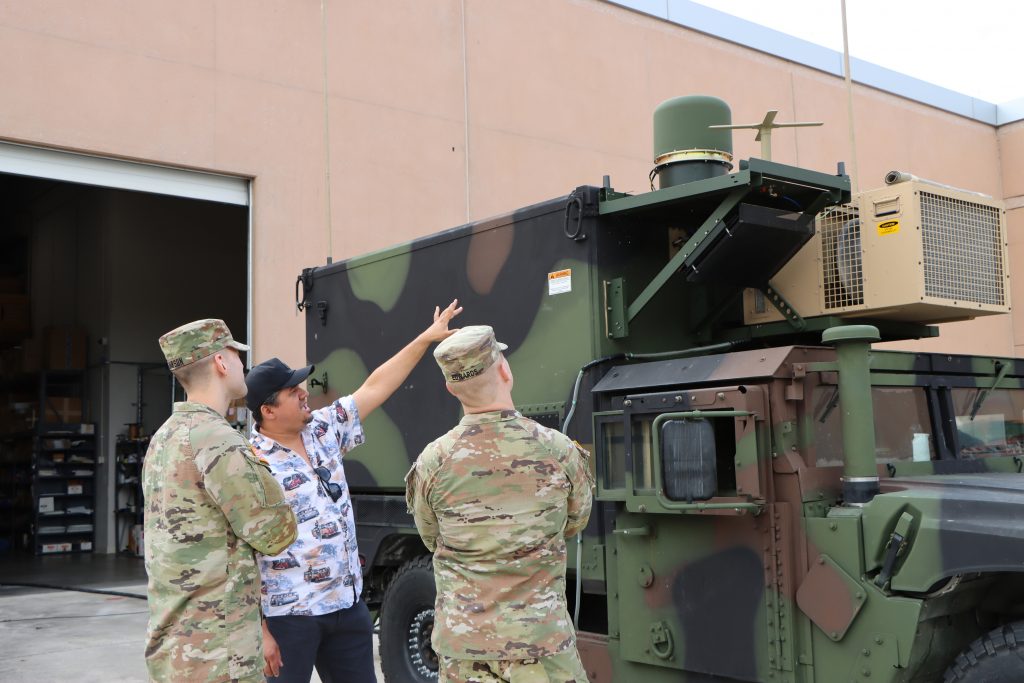 FULLY CAPABLESecond Lt. Nicholas Dawson and Spc. James Edwards listen to the Fort Cavazos TGS Operator New Equipment Training Geospatial Intelligence Trainer, Giovanni Nieves, discuss the Lot G’s quad band on the move capabilities and the satellite communications Ultra High Frequency antenna at Aberdeen Proving Ground, on Aug. 7, 2024. 