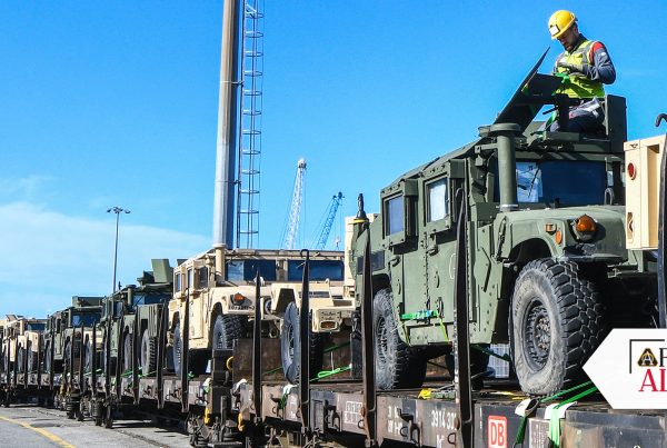 MOVE ON THROUGH Humvees and other equipment are loaded onto a train at the port of Livorno, Italy, to begin their trip to Eastern and Northern Europe. The EDA program transfers previously used, excess equipment from U.S. units to America’s foreign partners and allies. (Photo by Elena Baladelli, Training Support Activity Europe)