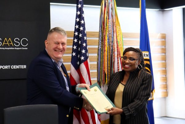 LEAD-Certificate-Acceptance, Caption: Kim S. Gibbons, LEAD Program Manager, accepting certificates on behalf of the graduates from Mr. Rob Richardson, Director of Acquisition Career Management (DACM).