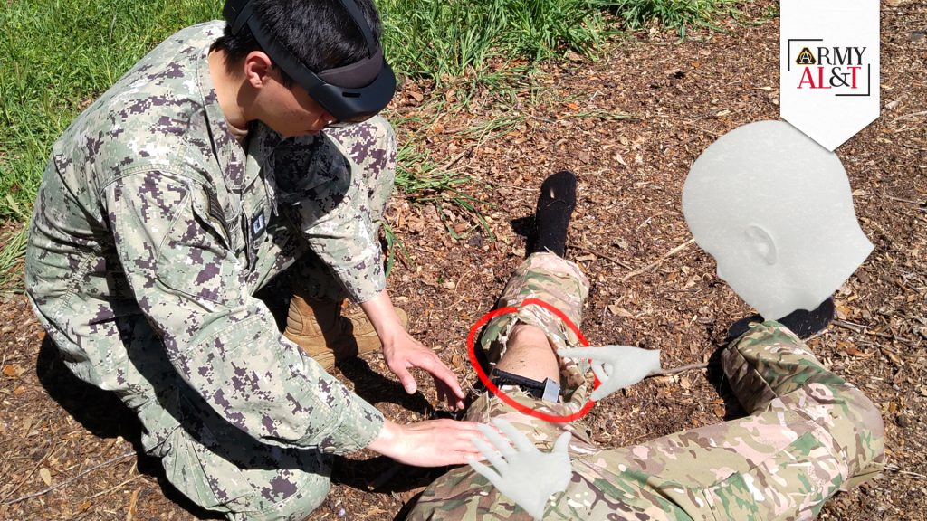 TEST SUBJECT: In a simulation, Navy Lt. Anh Nguyen, a master’s student who is currently evaluating the use of the IVAS augmented reality software, initiates treatment of a wounded warfighter by displaying virtual hands that provide previously recorded guidance in the procedure. (Photo courtesy of Christoph Leuze, Nakamir Inc.)