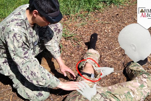 TEST SUBJECT: In a simulation, Navy Lt. Anh Nguyen, a master’s student who is currently evaluating the use of the IVAS augmented reality software, initiates treatment of a wounded warfighter by displaying virtual hands that provide previously recorded guidance in the procedure. (Photo courtesy of Christoph Leuze, Nakamir Inc.)