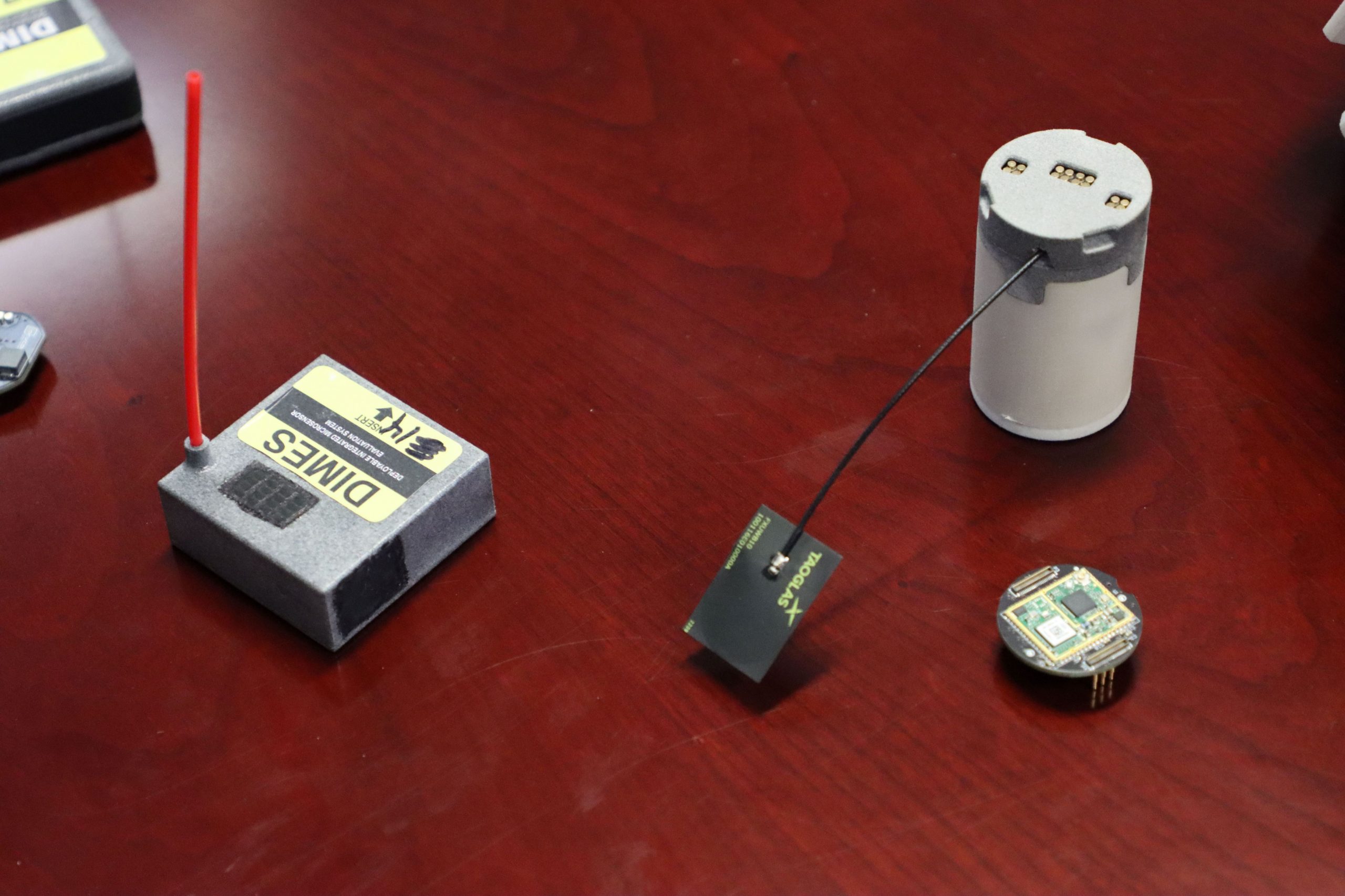 SHAPE SHIFTING: DIMES has gone through many iterations. The design shifted from being cylindrical (as shown on the right) to rectangular (as shown on the left) to maximize space efficiency and increase the surface area of the printed circuit board. (Photo by Ellie White, DEVCOM CBC)
