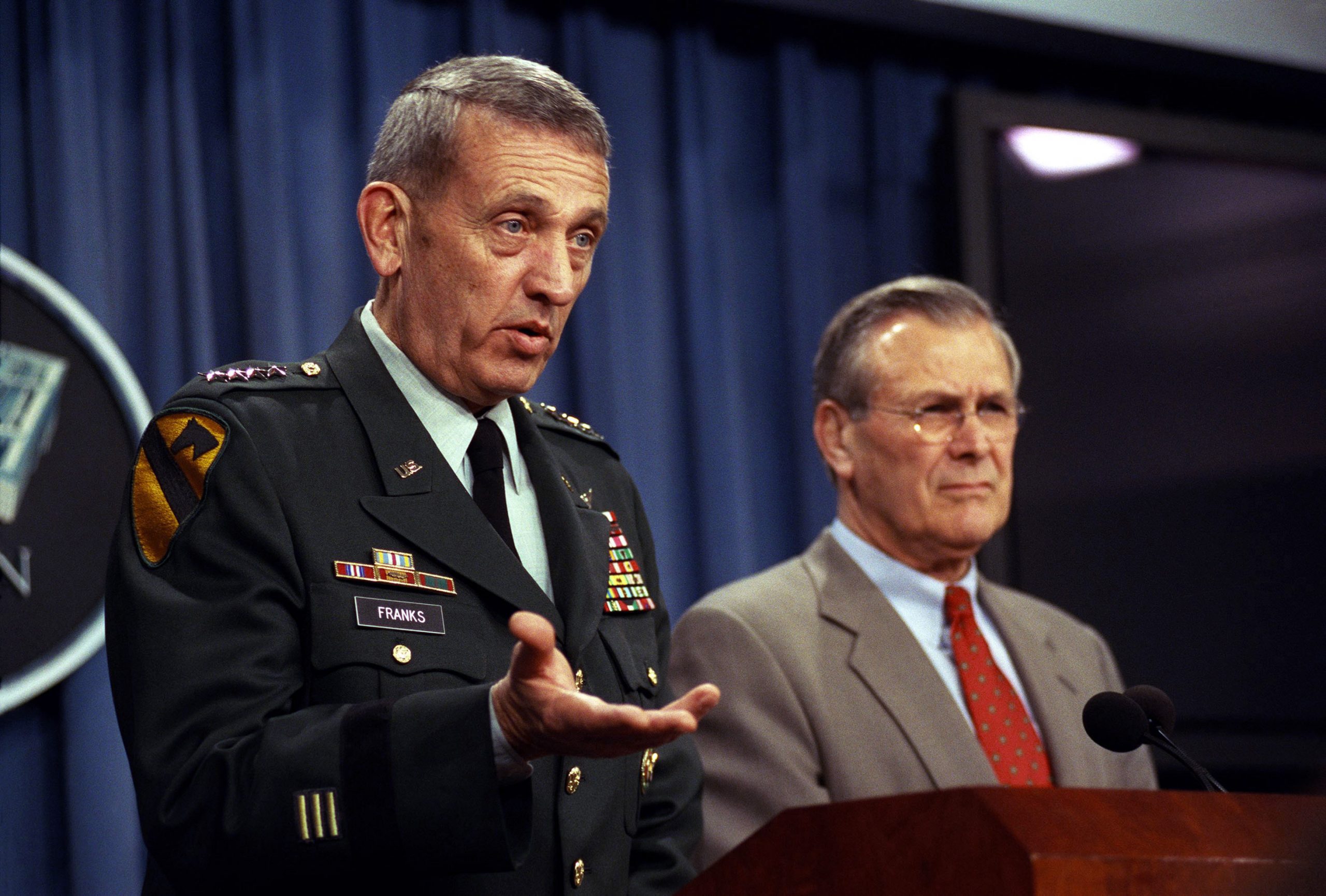 UPFRONT LEADERSHIP: Gen. Tommy Franks (left), commander in chief of U.S. Central Command, and former Secretary of Defense Donald Rumsfeld at a Pentagon briefing in March 2002. (Photo by Robert D. Ward, courtesy of U.S. National Archives)