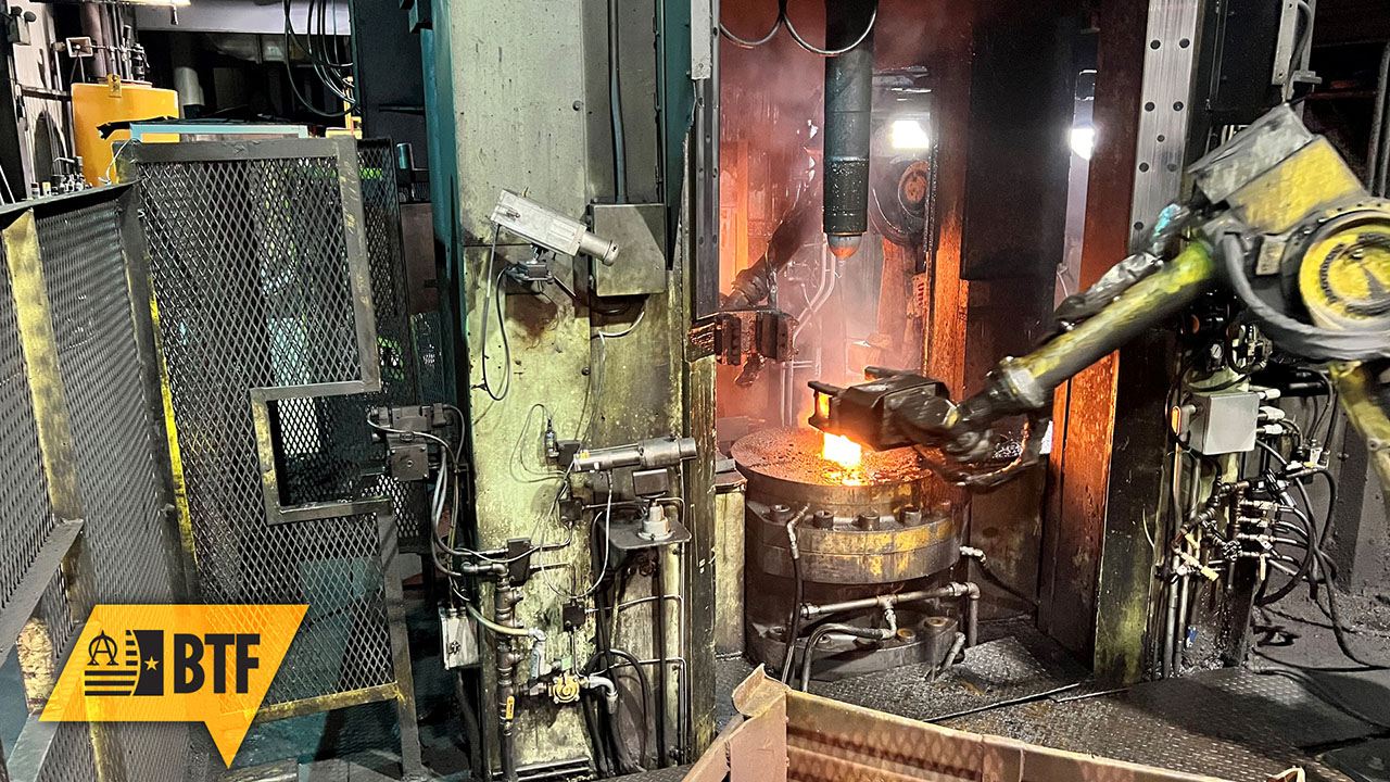 A robot arm loads hot metal cases into the Erie 1 Press at Scranton AAP in Pennsylvania. This is one of the steps in the production chain that can be simulated using the digital twin of the Scranton AAP. (Photo courtesy of PL JS)