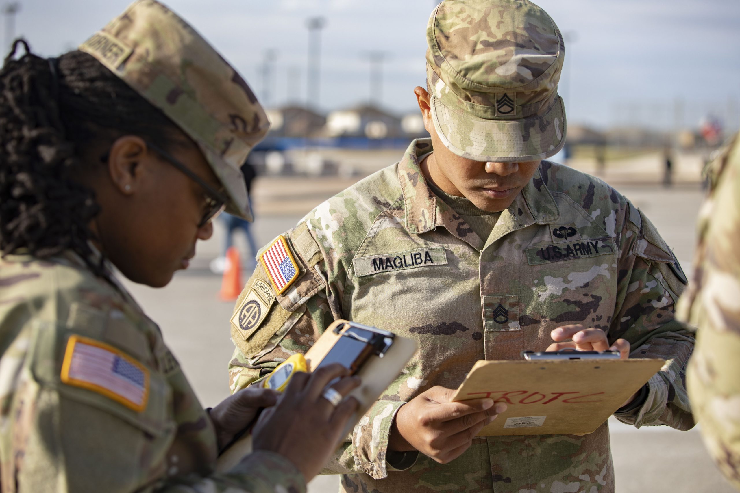 NCO photo of Staff Sgt. LaTrice Lewis-Turner and Staff Sgt. Phillip Magliba, contracting noncommissioned officers assigned to 410th Contracting Support Brigade, tally scores for the unarmed exhibition during the Thunderbird Classic at Lt. Col. Karen Wagner High School in San Antonio, Texas, on Oct. 14, 2023. Seven noncommissioned officers from U.S. Army South, 410th CSB, and U.S. Army North were among that 30 NCOs who volunteered to judge the largest drill competition in the state of Texas.