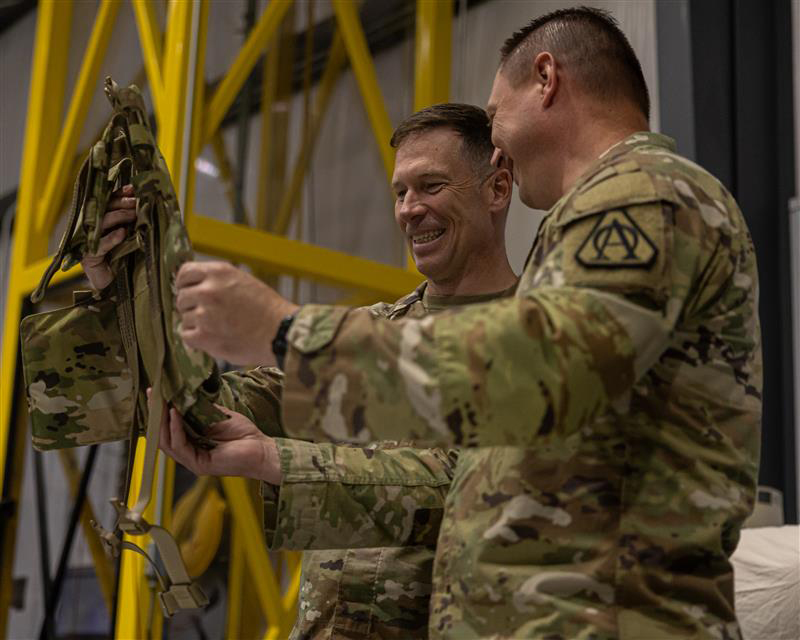 Officer photo of U.S. Army Col. James Lindh, project manager of Soldier Survivability (PM SSV), a portfolio within the Program Executive Office (PEO) Soldier, and Lt. Col. Brandon Nixon, product manager (PdM) for Air Warrior, examine modular components of the Aircrew Combat Equipment (ACE) vest during a full-rate production kickoff, at the Aerial Machine and Tool Corp., manufacturing facility in Meadows of Dan, Virginia, June 4, 2025. Senior leaders attended the event in commemoration of the Army’s most significant upgrades to rotary-wing aircrew protection in more than two decades.